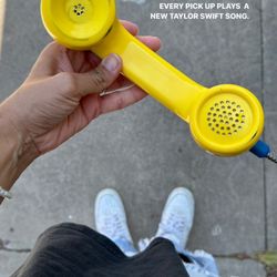Yellow Pay Phone - A phone that plays Taylor Swift songs.