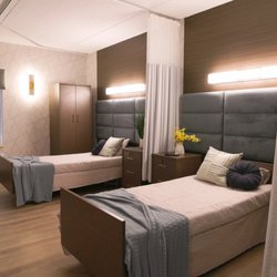 Medford Multicare Center - A bright and comfortable semi-private resident room at Medford Multicare Center, featuring modern furnishings, privacy curtains, ample natur