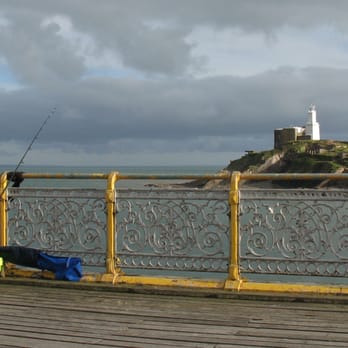 Mumbles Pier - Mumbles Pier - fisherman and Mumbles Lighthouse - Landmarks & Historical Buildings Near Me - Swansea, SWA