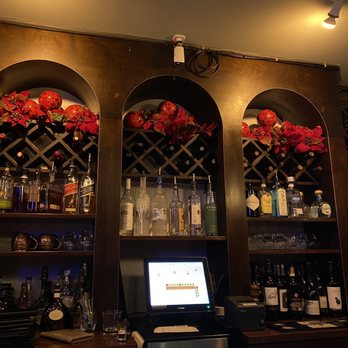 The Palazzo Restaurant - a bar with wine bottles on the shelves - Italian Near Me - Cleveland, Ohio
