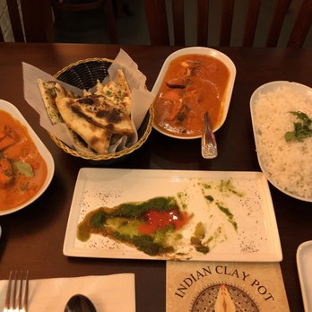 Indian Clay Pot - Spicy Naan, Chicken Tikka Masala (left), Butter Chicken (middle right), Basmati Rice (far right) - Indian Near Me - Chicago, Illinois