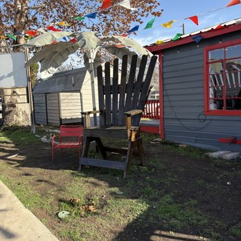 Everybody Loves Raymonds - Picture opportunity in front oversized patio chair and palm tree umbrella - Tacos Near Me - San Antonio, Texas
