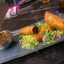 a plate of fried food with dipping sauce