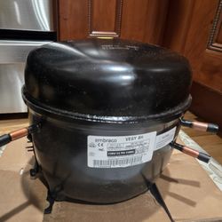 Clickfix - "Replacement compressor for a refrigerator, ready for installation after diagnosing compressor failure.