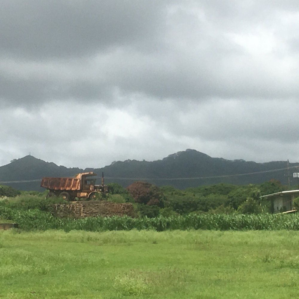 Koloa Sugar Monument - Faraway dump trucks rusting in the sun. - Parks Near Me - Koloa, Hawaii Koloa Sugar Monument - Faraway dump trucks rusting in the sun. - Parks Near Me - Koloa, Hawaii