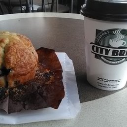 Hot chocolate with whipped cream and a blueberry muffin.