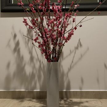 The Alexander - a vase with pink flowers in front of a mirror - Italian Near Me - Anaheim, California