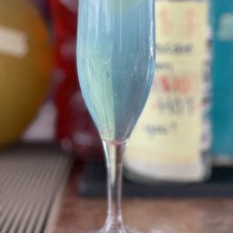 a blue drink in a wine glass a blue drink in a wine glass