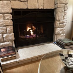 Elite Fireplace Service & Repair - Fireplace with fire logs by Elite.