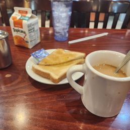 Coffee, orange juice, and toast with butter. Coffee, orange juice, and toast with butter.