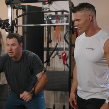 Superset Fitness - Trainer Greg teaching a male client how to use the cable machine. - Gyms Near Me - Denver, Colorado Superset Fitness - Trainer Greg teaching a male client how to use the cable machine. - Gyms Near Me - Denver, Colorado