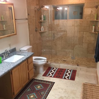 Tenrik Builders - Travertine tile, glass shower doors and granite counters in master bath. - General Contractors Near Me
