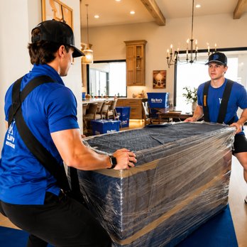 Big Ben's Moving and Storage - Two Big Ben's Moving & Storage professionals carefully carrying a large wrapped furniture piece through a residential home us... - Self Storage Near Me - St. George, Utah Big Ben's Moving and Storage - Two Big Ben's Moving & Storage professionals carefully carrying a large wrapped furniture piece through a residential home us... - Self Storage Near Me - St. George, Utah