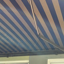 Harrison Awnings - 20' Wide x 10' Projection SunPro Brand retractable awning in bronze frame with custom Sunbrella fabric (See the lights built into the arms)