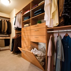 A Better Closet - Medium wood grain and matte nickel closet with pull-out laundry hamper and double hanging clothes.