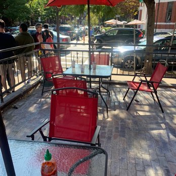 Pho Real - Boston - a patio with red chairs and umbrellas - Vietnamese Near Me - Boston, Massachusetts Pho Real - Boston - a patio with red chairs and umbrellas - Vietnamese Near Me - Boston, Massachusetts