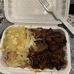 a container of meat and cabbage with a fork a container of meat and cabbage with a fork