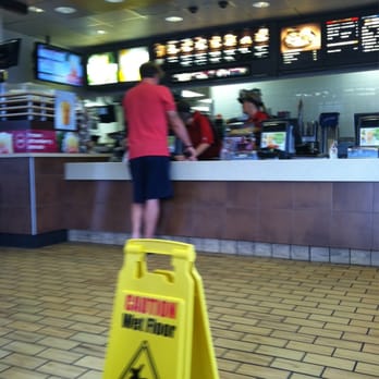 McDonald's - a caution sign in front of a counter - Coffee & Tea Near Me - Cumming, Georgia McDonald's - a caution sign in front of a counter - Coffee & Tea Near Me - Cumming, Georgia