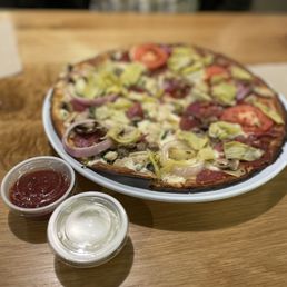 Cauliflower crust with two different halves for toppings.