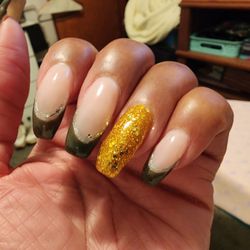 Jacqueline's Nail Salon - The color is dark green trimmed in silver and a gold disco nail.