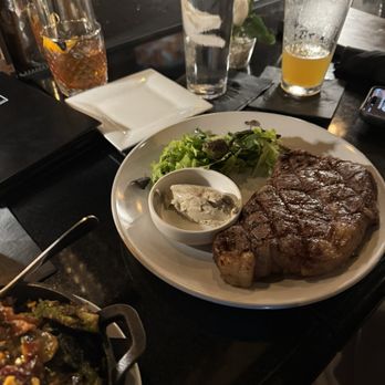 Cody's Restaurant Bar & Patio - Ribeye with greens and black garlic butter. - Lounges Near Me - San Marcos, Texas Cody's Restaurant Bar & Patio - Ribeye with greens and black garlic butter. - Lounges Near Me - San Marcos, Texas