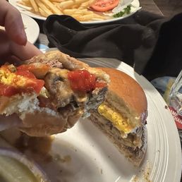 Bacon cheeseburger in background and a mushroom blue cheese and fried egg burger cut in half, 10 ounces of luscious taste!!