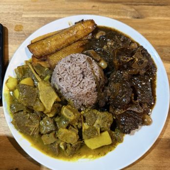True Island Grille - Oxtail, curry goat, sweet plantain, rice and peas. - Caribbean Near Me - Orlando, Florida True Island Grille - Oxtail, curry goat, sweet plantain, rice and peas. - Caribbean Near Me - Orlando, Florida
