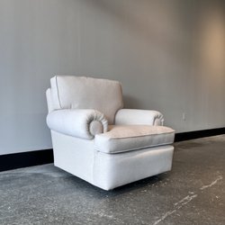 The ReBorn House - Oversized Club Chair with vintage round brass casters.