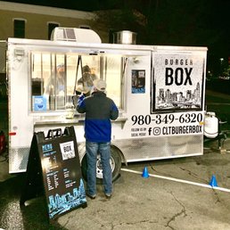 a man ordering food from a food truck a man ordering food from a food truck