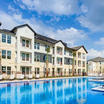 Legacy at Cibolo - a large swimming pool in front of an apartment building - Apartments Near Me - Boerne, Texas Legacy at Cibolo - a large swimming pool in front of an apartment building - Apartments Near Me - Boerne, Texas