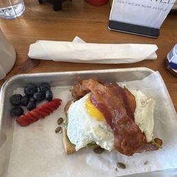 Avocado toast with a sunny side up egg and bacon Avocado toast with a sunny side up egg and bacon