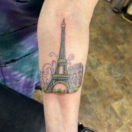 A tattoo of Eiffel Tower and Arc De Triomphe. A tattoo of Eiffel Tower and Arc De Triomphe.
