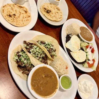 El Amate - Pork and cheese + chicken and cheese pupusas. Tacos de Asada (front). Bistec a Caballo (back). - Salvadoran Near Me - Palm Bay, Florida