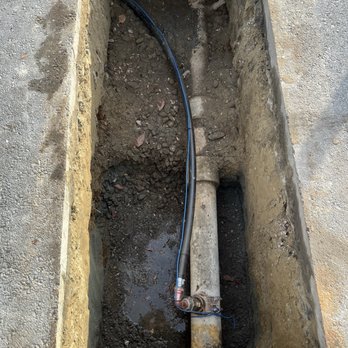 Lindstrom Company Plumbing - new water service attached to water main - Plumbing Near Me