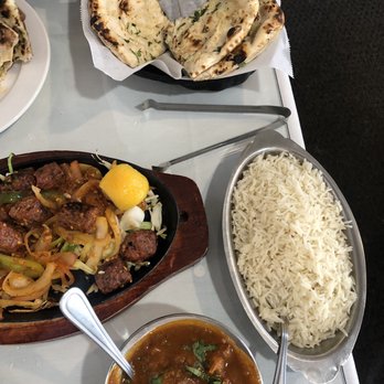 Tandoori Flame - Spicy(optional) goat curry, spicy(optional) seekh kebabs, rice, and garlic naan - Indian Near Me - Indianapolis, Indiana Tandoori Flame - Spicy(optional) goat curry, spicy(optional) seekh kebabs, rice, and garlic naan - Indian Near Me - Indianapolis, Indiana