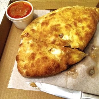 Carmine’s Pizza Kitchen - This Calzone is the perfect size for two seniors.  I didn't use any sauce.  Hubby ate one slice with and 1 without the sauce; liked both. - Pizza Near Me - Henderson, Nevada
