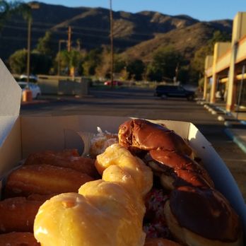 Raised Donuts - a box of doughnuts in a parking lot - Donuts Near Me - Lake Elsinore, California Raised Donuts - a box of doughnuts in a parking lot - Donuts Near Me - Lake Elsinore, California