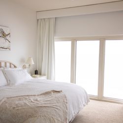Interiors by Thalia - Drapery with a small cornice as a window treatment creates a beautiful frame for the Gulf Coast condo.
