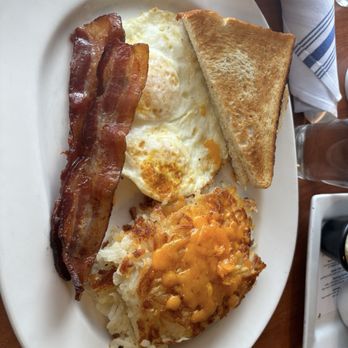 Blue's Egg + Bakery - 2 Local Eggs (over medium), bacon, sourdough toast, and cheesey browns. - Breakfast & Brunch Near Me - Milwaukee, Wisconsin