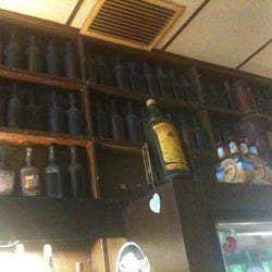 Jack's Bar - These overstock shelves (full bottles from 50+ years ago) run the full length of this place.