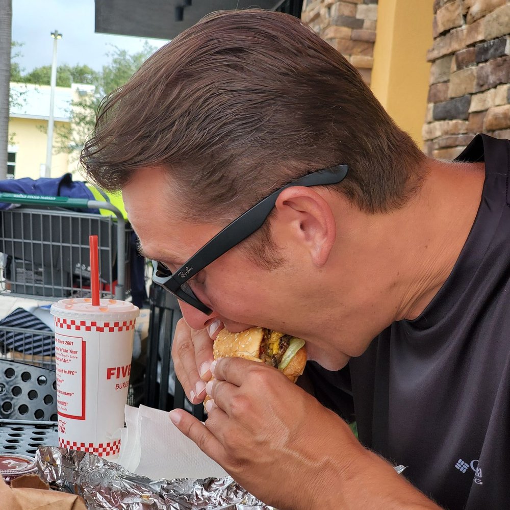 Five Guys - Got a shot of my buddy crushing his burger - Burgers Near Me - Delray Beach, Florida Five Guys - Got a shot of my buddy crushing his burger - Burgers Near Me - Delray Beach, Florida