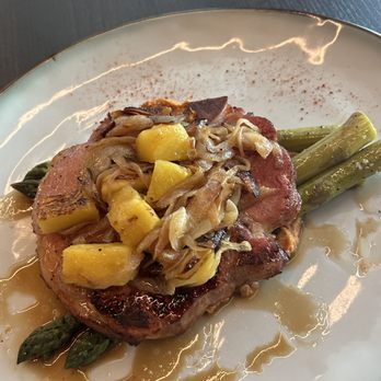 Oceana - Smoked pork chop on a hummus/red pepper base with asparagas - Seafood Near Me - Rancho Mirage, California Oceana - Smoked pork chop on a hummus/red pepper base with asparagas - Seafood Near Me - Rancho Mirage, California