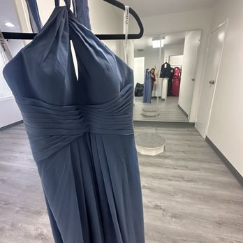 Simple To Perfect Studio - Bridesmaids dress altered with the area for hemming dresses in the background - Sewing & Alterations Near Me - Santa Ana, California