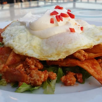 Ado's Kitchen & Bar - Mexican chiliquiles with fresh lettuce rustic chicken tomato salsa and jalapeño crema - Breakfast & Brunch Near Me - Boulder, Colorado