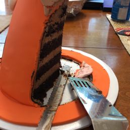 This traffic cone is made of layers of chocolate cake and frosting. This traffic cone is made of layers of chocolate cake and frosting.