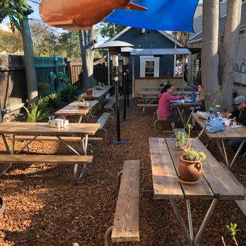 Petiscos - As you can see theirs plenty of benches. And some interesting decorations around the yard. I love their old lunch pails got their napkins. - Tacos Near Me - Claremont, California
