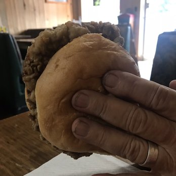 Cajun Joe's Cafe - a hand holding a hamburger - Cajun/Creole Near Me - Newton, Texas