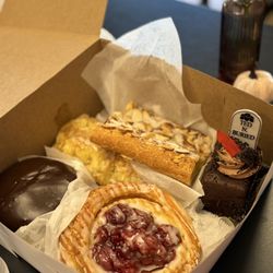 Kirsten's Danish Bakery - Cherry pastry, Bavarian cream donut, Kringle, apple pastry, and chocolate cake