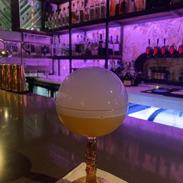 a glass of alcohol on a bar counter a glass of alcohol on a bar counter