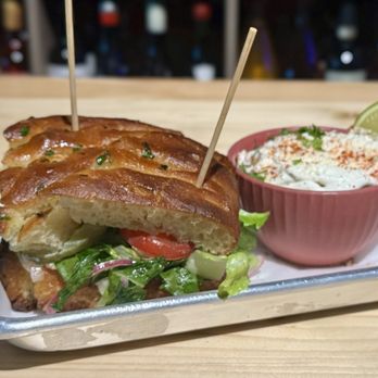 Salud Beer Shop - Lex Diamond sandwich with an elote salad and lime wedge on the side. - Beer, Wine & Spirits Near Me - Charlotte, North Carolina